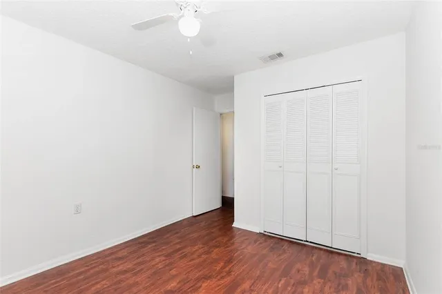 an empty room with wooden floor