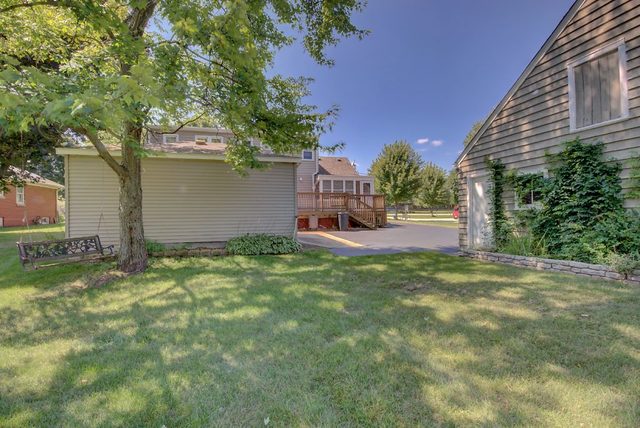 1875 Church Road Aurora, IL 60505 - Photo 22 of 26 a backyard of a house with table and chairs under an large tree