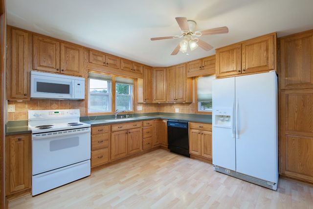 1875 Church Road Aurora, IL 60505 - Photo 5 of 26 a kitchen with stainless steel appliances granite countertop a stove sink and refrigerator