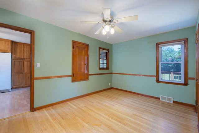 1875 Church Road Aurora, IL 60505 - Photo 7 of 26 a view of an empty room with wooden floor and a window