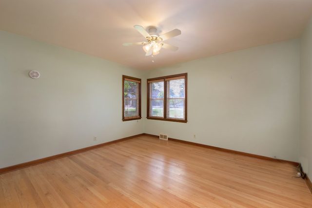1875 Church Road Aurora, IL 60505 - Photo 8 of 26 wooden floor in an empty room with a window