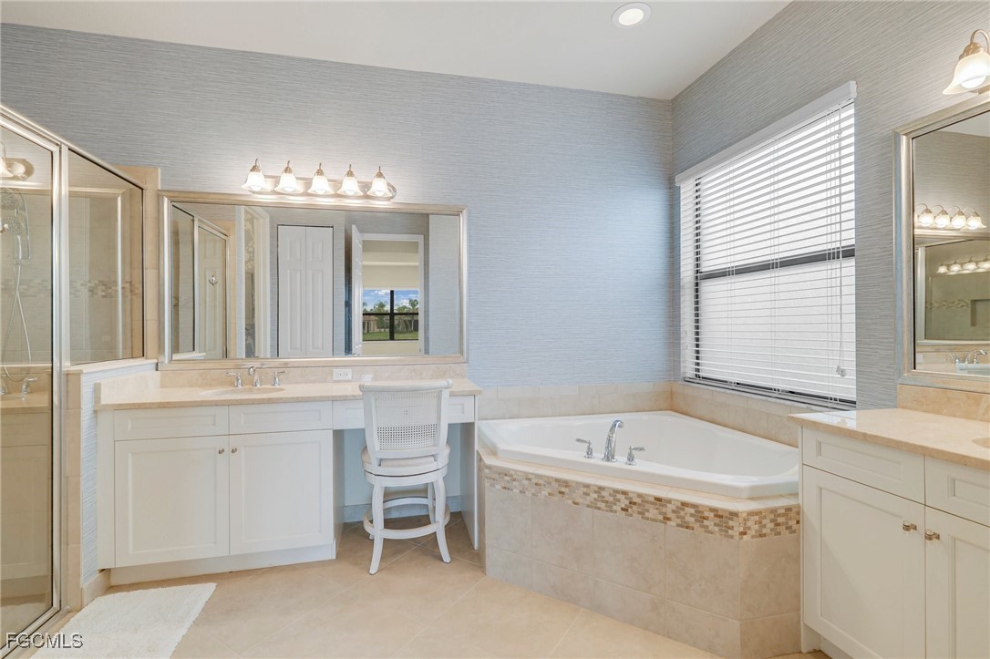11643 Meadowrun Circle Fort Myers, FL 33913 - Photo 15 of 39 a spacious bathroom with a tub sink and mirror