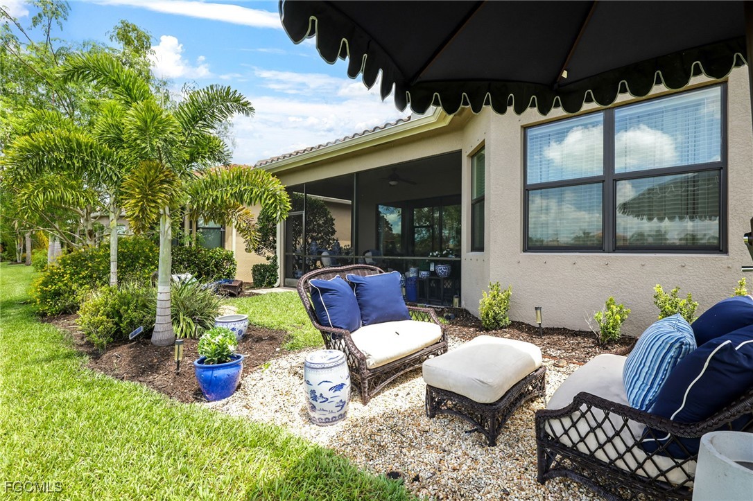 11643 Meadowrun Circle Fort Myers, FL 33913 - Photo 25 of 39 a view of a patio with couches table and chairs and potted plants