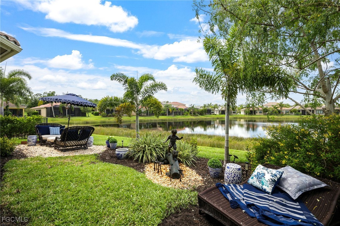 11643 Meadowrun Circle Fort Myers, FL 33913 - Photo 26 of 39 a view of a lake with couches chairs and a table