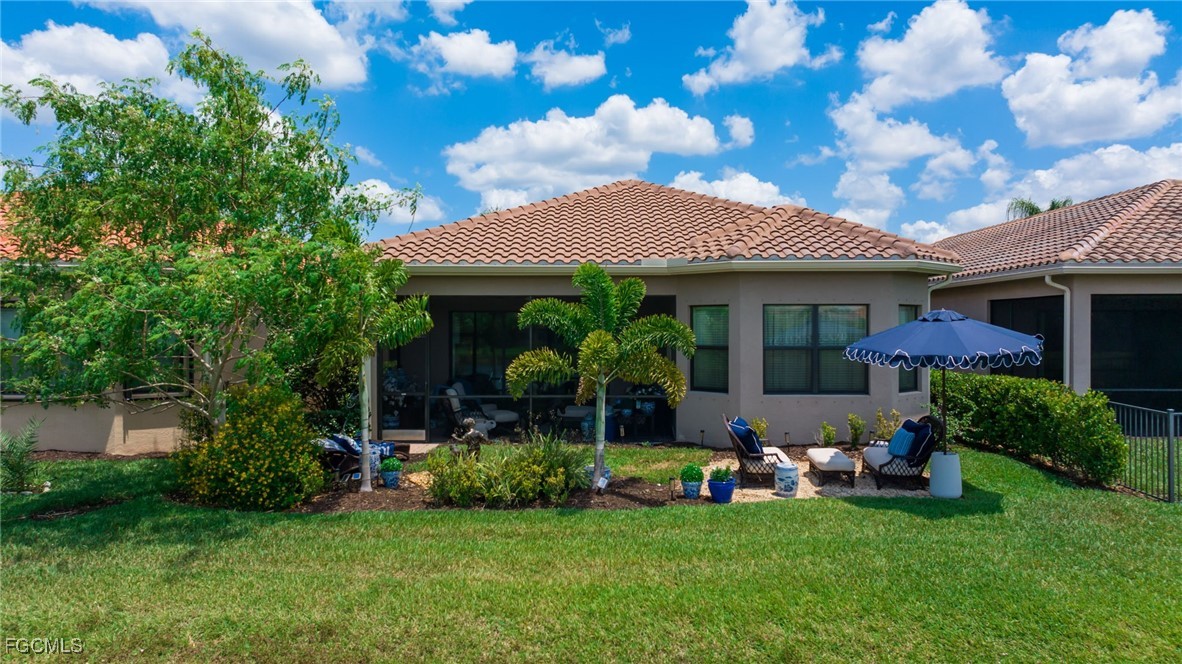 11643 Meadowrun Circle Fort Myers, FL 33913 - Photo 28 of 39 a front view of a house with a garden and plants