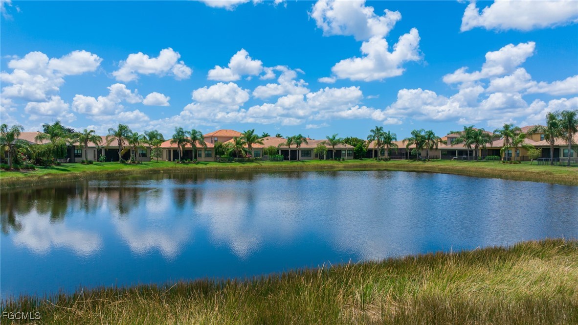 11643 Meadowrun Circle Fort Myers, FL 33913 - Photo 32 of 39 a view of a lake with houses in the background