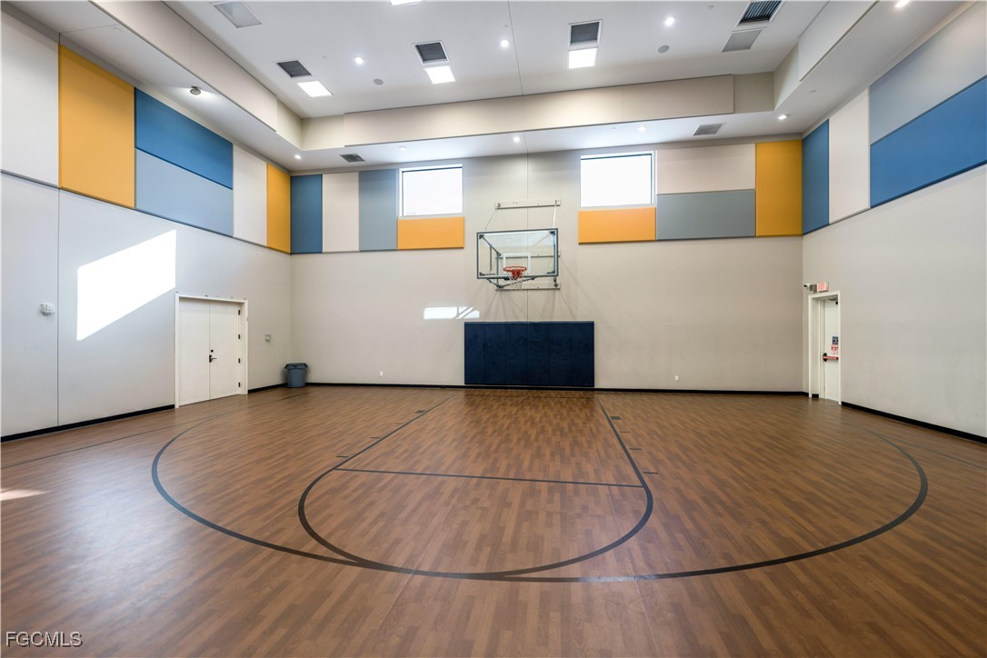 11643 Meadowrun Circle Fort Myers, FL 33913 - Photo 36 of 39 an empty room with wooden floor and white cabinet