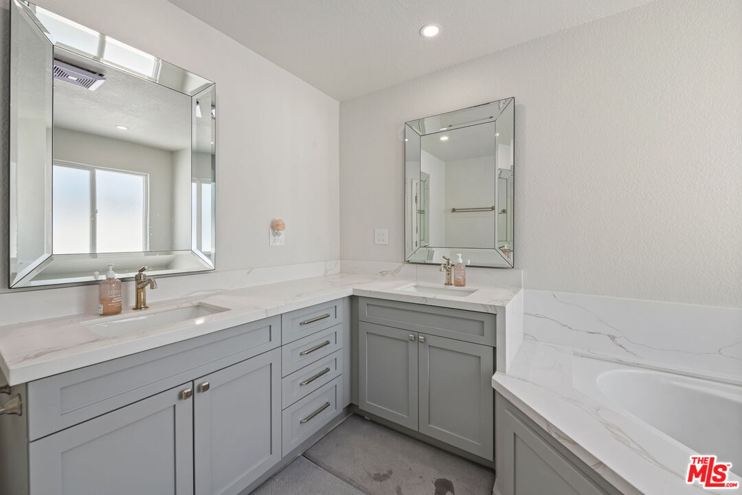 222 West Imperial Avenue, Unit 3 El Segundo, CA 90245 - Photo 13 of 24 a bathroom with a sink double vanity granite tub shower and a mirror