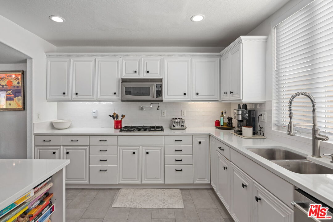 222 West Imperial Avenue, Unit 3 El Segundo, CA 90245 - Photo 7 of 24 a kitchen with cabinets stainless steel appliances and a sink