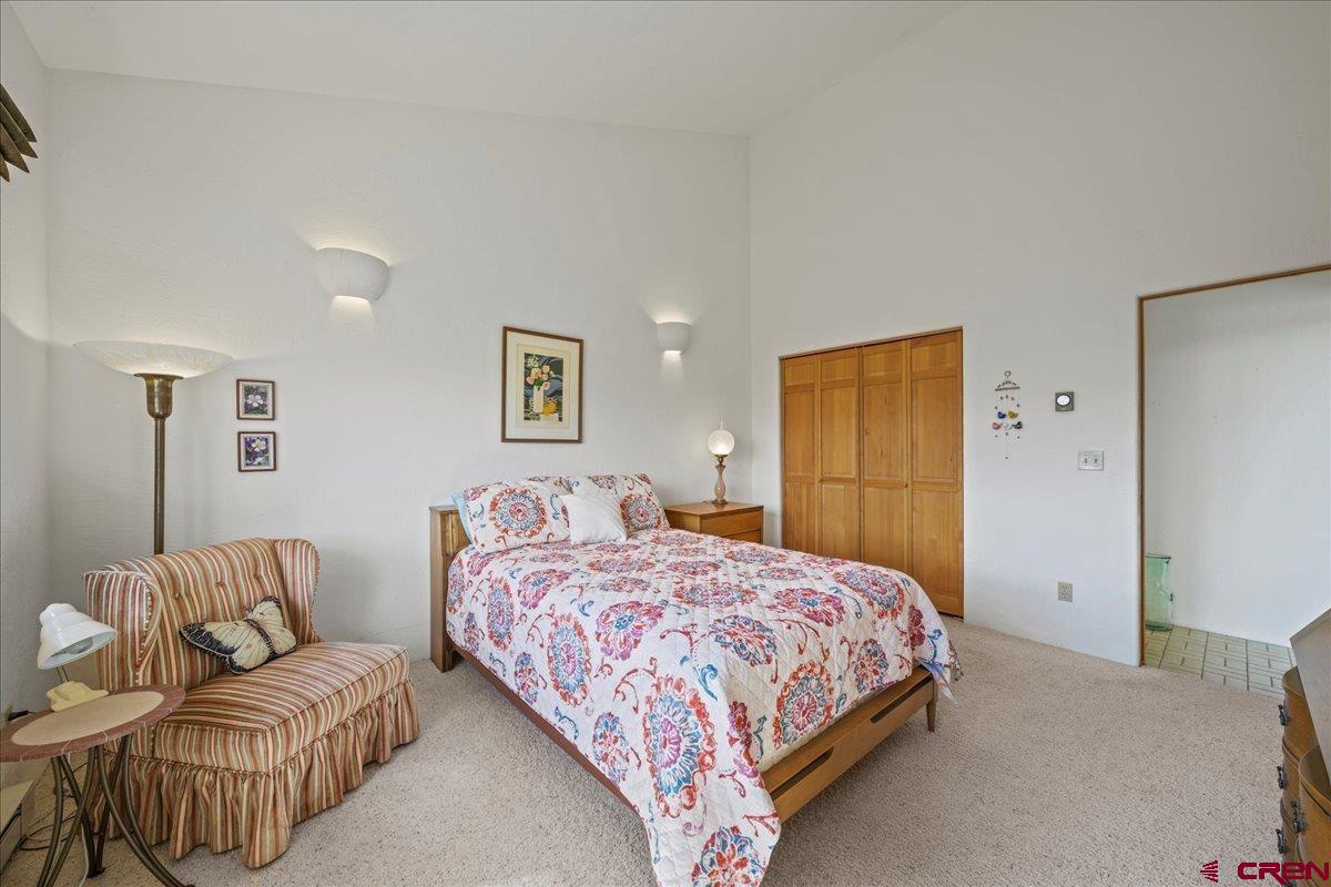 12979 County Road 1 Ridgway, CO 81432 - Photo 23 of 35 a bedroom with a bed and couch