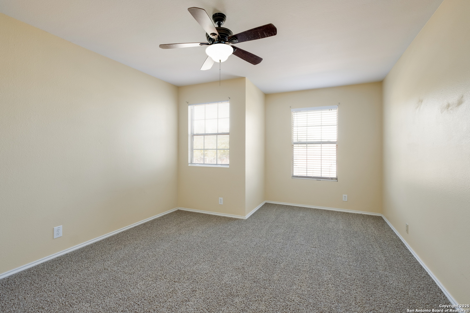 249 Michelle Lane Boerne, TX 78006 - Photo 13 of 17 an empty room with windows and fan