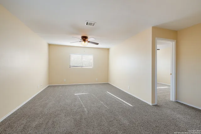 an empty room with windows and closet
