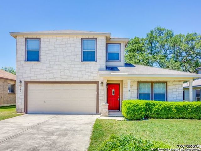 249 Michelle Lane Boerne, TX 78006 - Photo 2 of 17 a front view of a house with a yard and garage