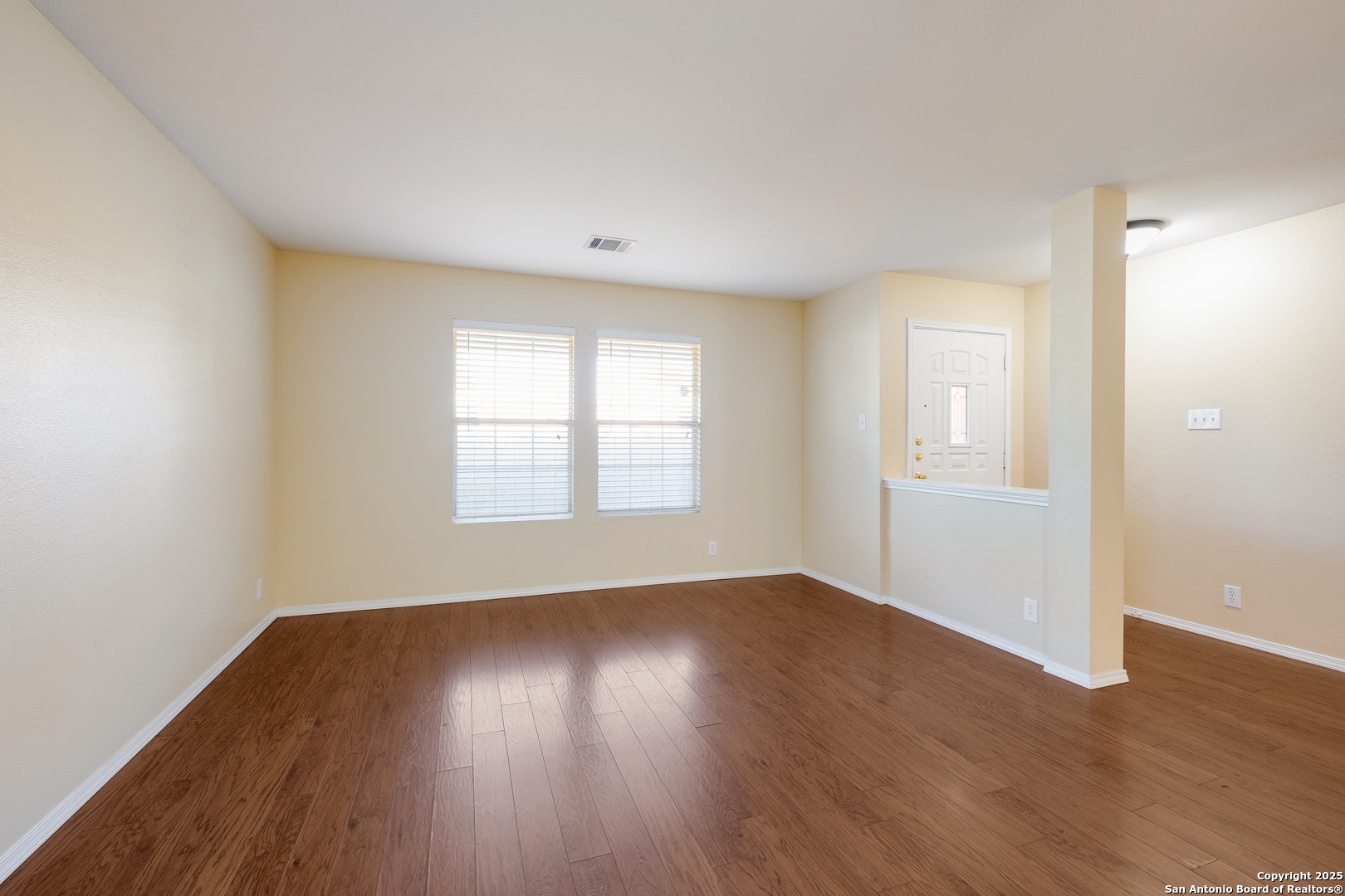 249 Michelle Lane Boerne, TX 78006 - Photo 5 of 17 an empty room with wooden floor and windows