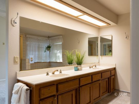 323 West Pilgrim Court Ridgecrest, CA 93555 - Photo 26 of 35 a bathroom with a sink and a mirror