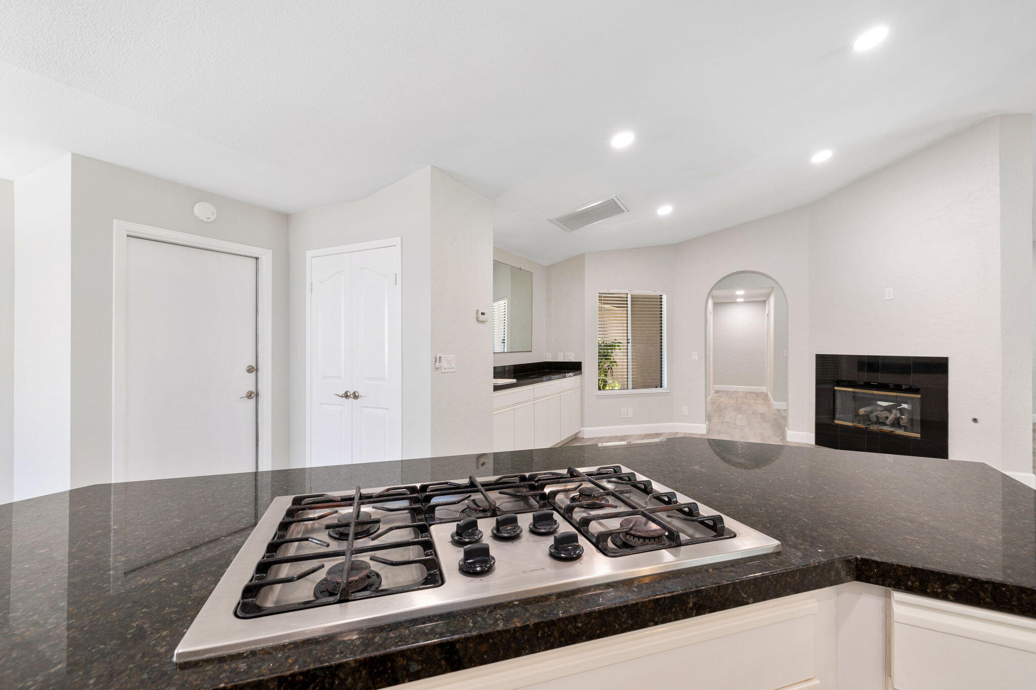 39495 Regency Way Palm Desert, CA 92211 - Photo 11 of 55 a kitchen with granite countertop stove and cabinets