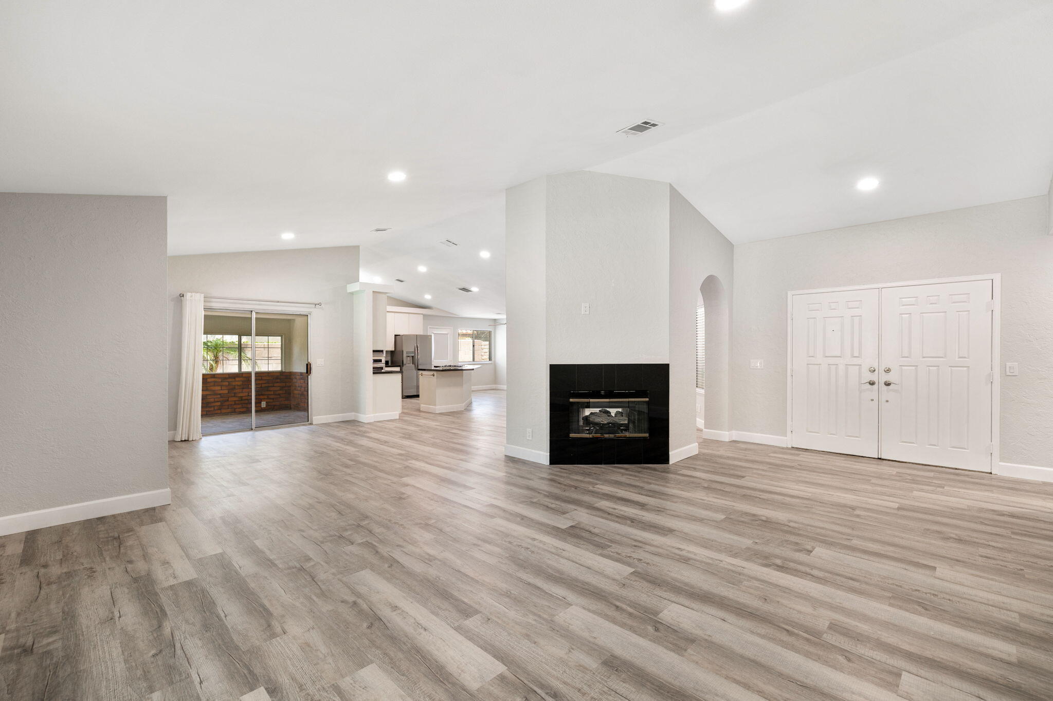 39495 Regency Way Palm Desert, CA 92211 - Photo 17 of 55 a view of empty room with wooden floor and fireplace
