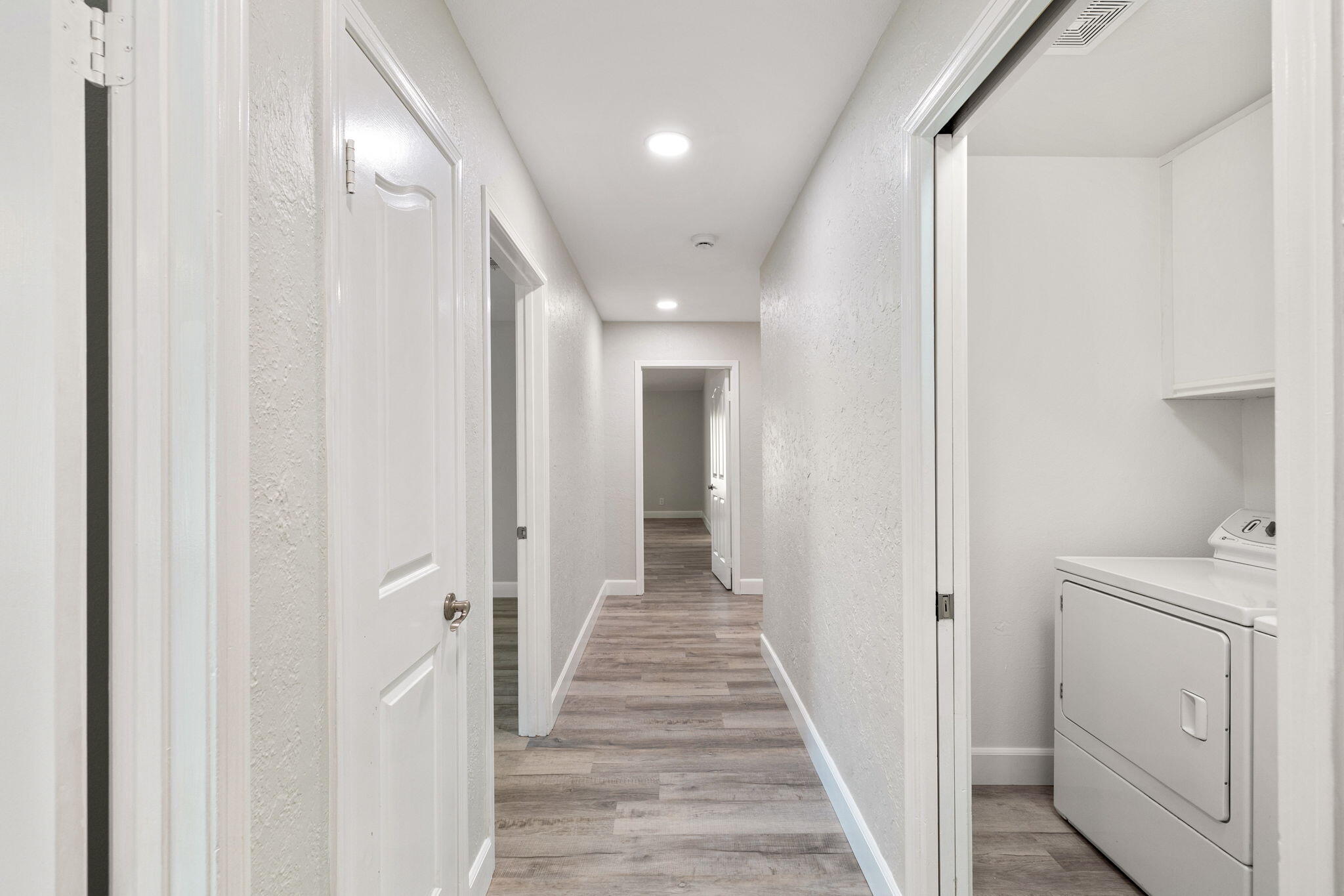 39495 Regency Way Palm Desert, CA 92211 - Photo 24 of 55 a view of a hallway with closet and wooden floor