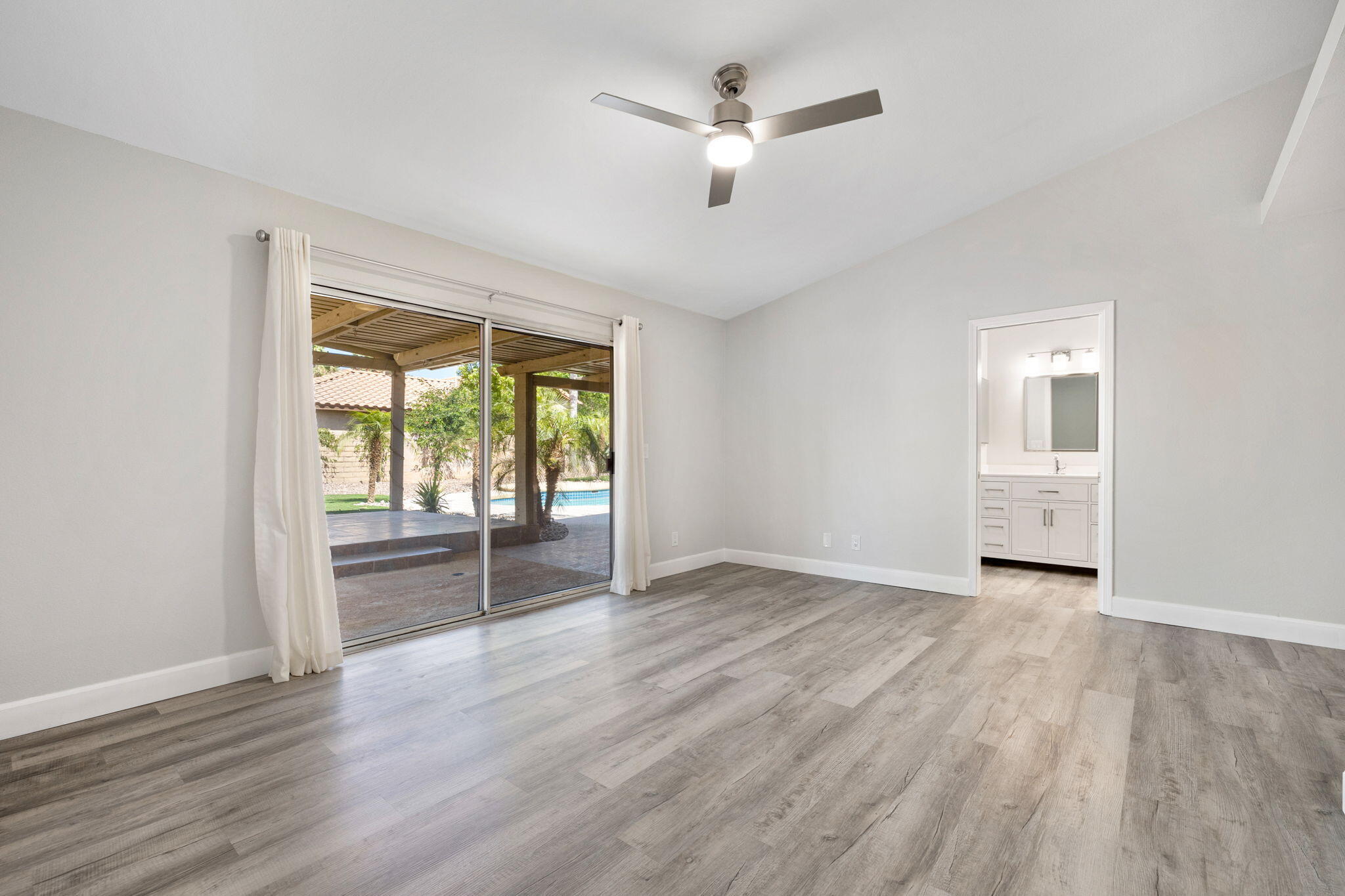 39495 Regency Way Palm Desert, CA 92211 - Photo 27 of 55 a view of empty room with wooden floor and fan