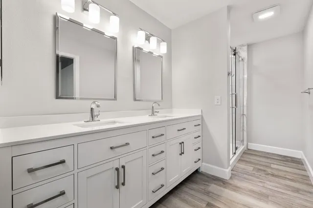 a bathroom with a granite countertop toilet sink and mirror