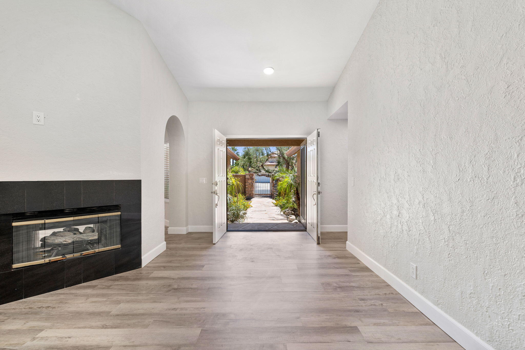 39495 Regency Way Palm Desert, CA 92211 - Photo 3 of 55 a view of an empty room with a fireplace and a window