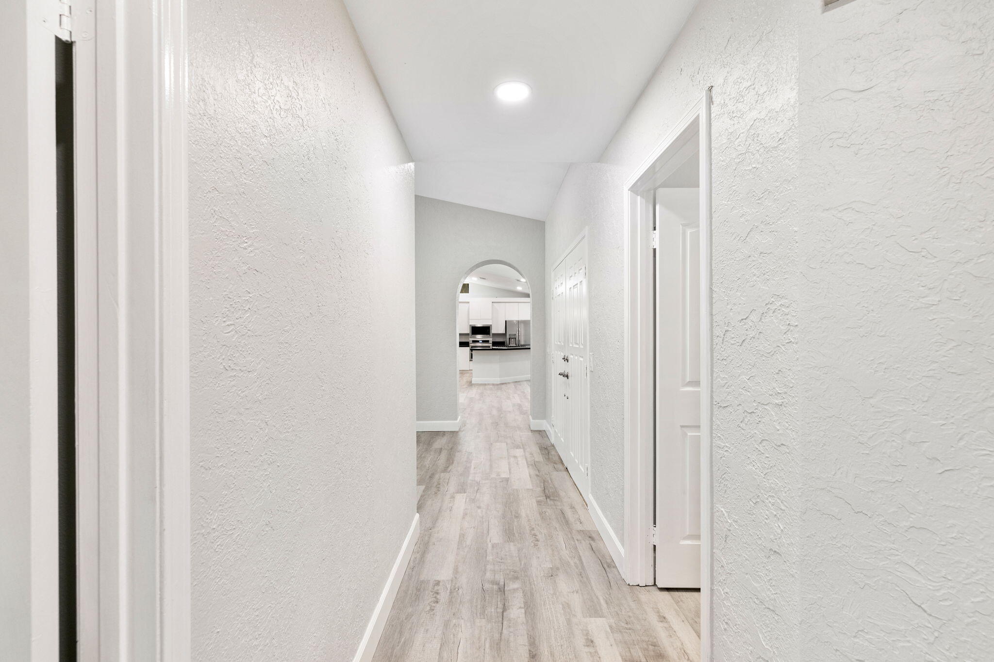 39495 Regency Way Palm Desert, CA 92211 - Photo 31 of 55 a view of a hallway with wooden floor and staircase