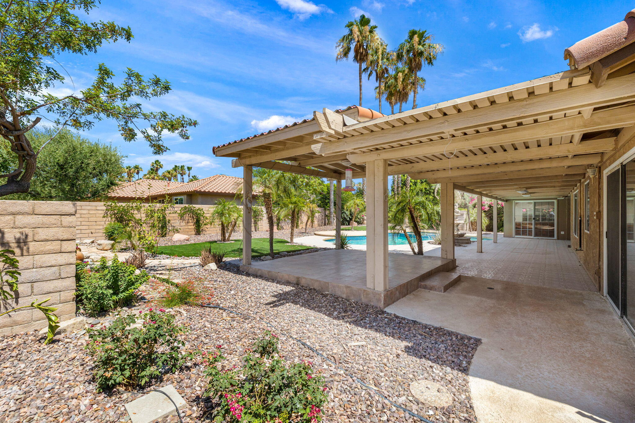 39495 Regency Way Palm Desert, CA 92211 - Photo 37 of 55 a view of a patio with table and chairs potted plants