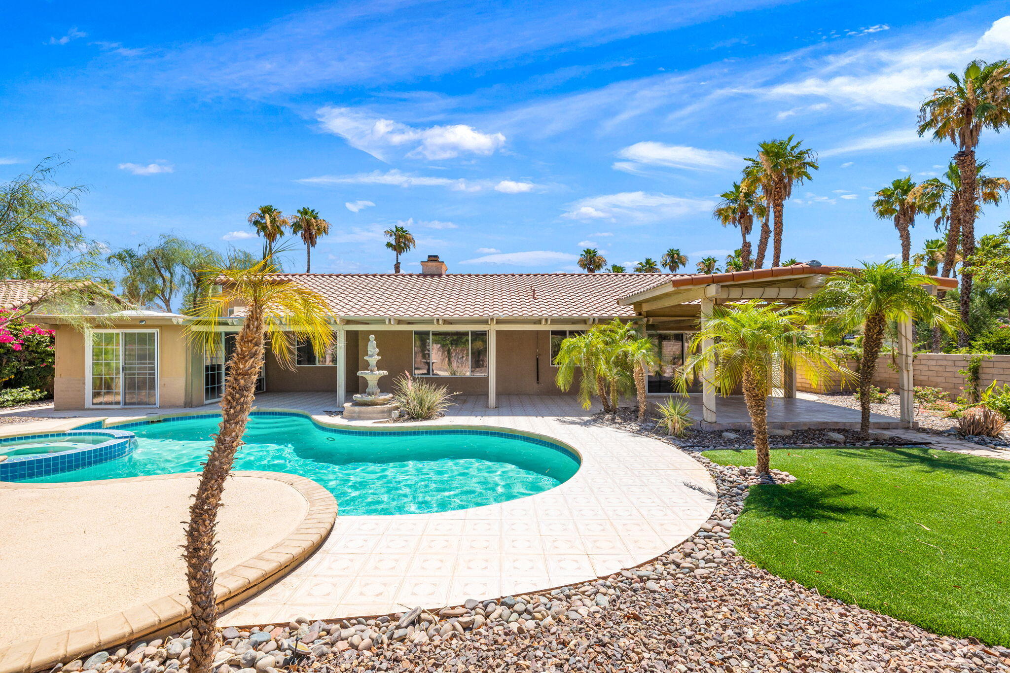 39495 Regency Way Palm Desert, CA 92211 - Photo 41 of 55 a view of a house with swimming pool and a yard