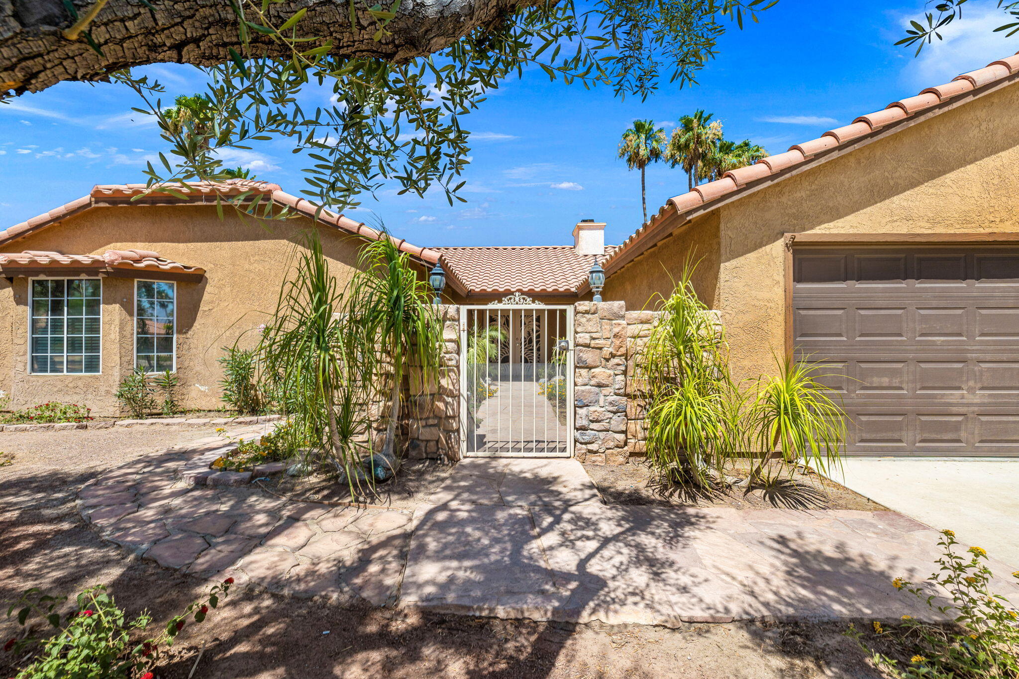 39495 Regency Way Palm Desert, CA 92211 - Photo 49 of 55 a view of a house with a large tree