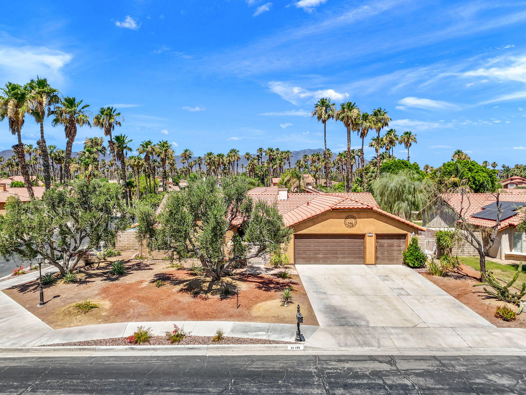 39495 Regency Way Palm Desert, CA 92211 - Photo 51 of 55 a front view of a house with a yard