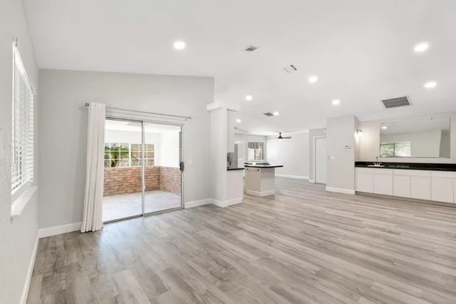 a view of a kitchen with cabinets stainless steel appliances a sink and a counter top space