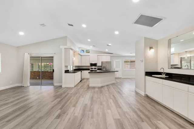 a kitchen with a sink and white cabinets