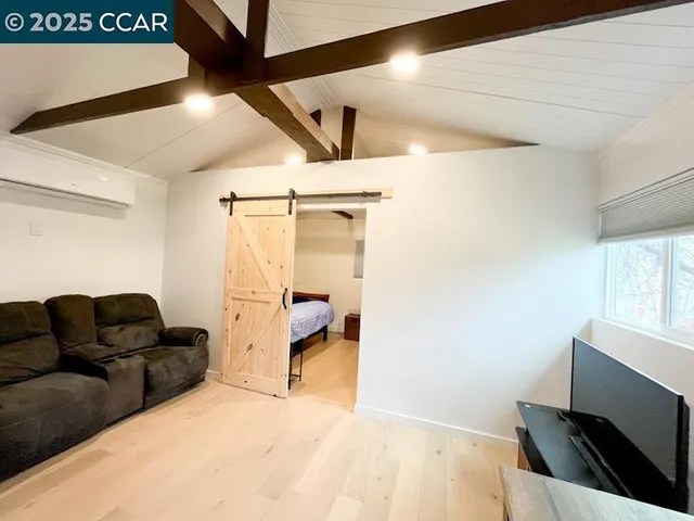 a bedroom with a bed and flat screen tv