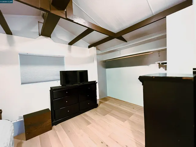 a bathroom with a granite countertop sink toilet mirror and shower