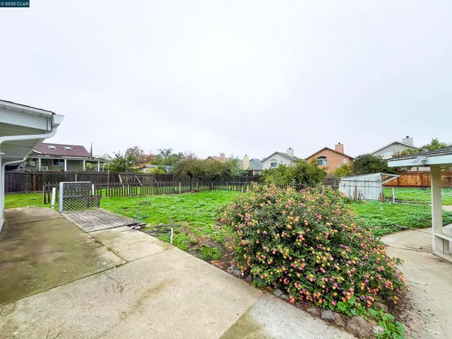 a view of a house with a yard and table and chairs