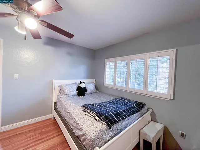 a bed sitting in a bedroom next to a window