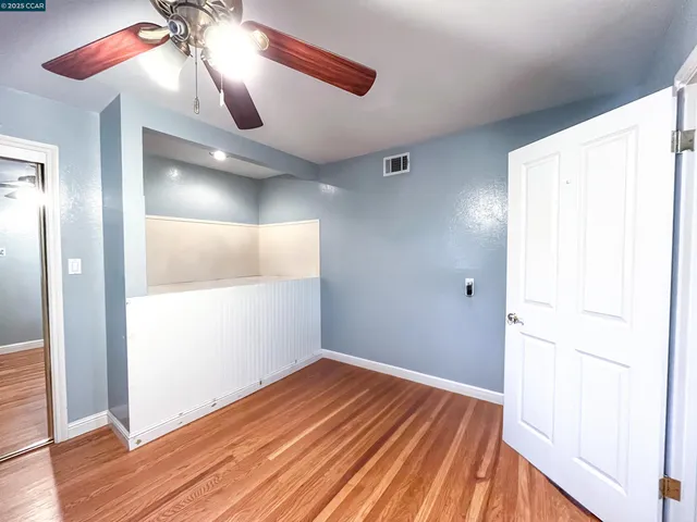 a view of a room with wooden floor