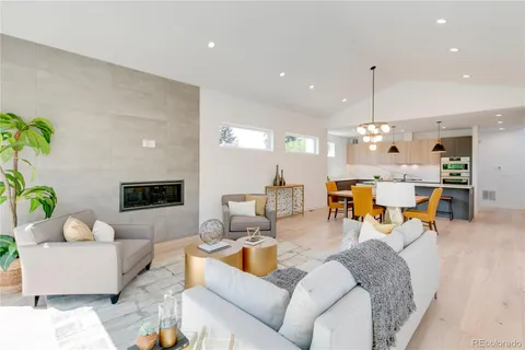 a living room with furniture and a chandelier