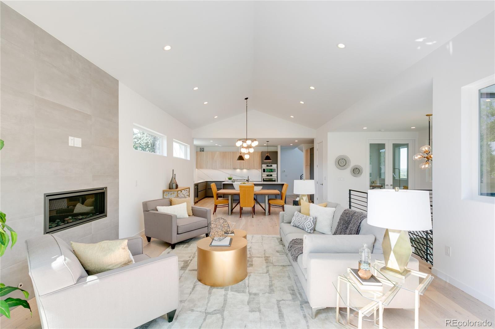 4077 Everett Street Wheat Ridge, CO 80033 - Photo 12 of 50 a living room with furniture a fireplace and a chandelier
