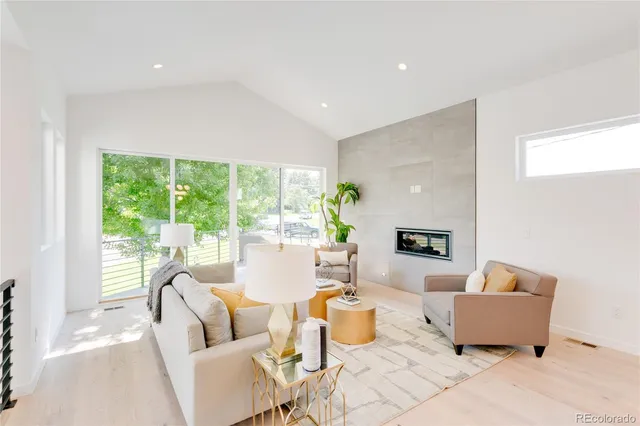 a kitchen with stainless steel appliances kitchen island granite countertop a table chairs and a refrigerator