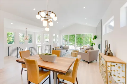 a kitchen with a table chairs stove and wooden floor