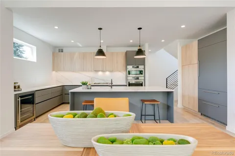 a very nice looking dining room with a large window and chandelier