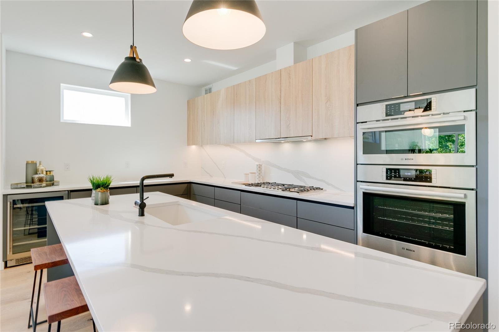 4077 Everett Street Wheat Ridge, CO 80033 - Photo 18 of 50 a kitchen with stainless steel appliances granite countertop a stove a sink and a refrigerator