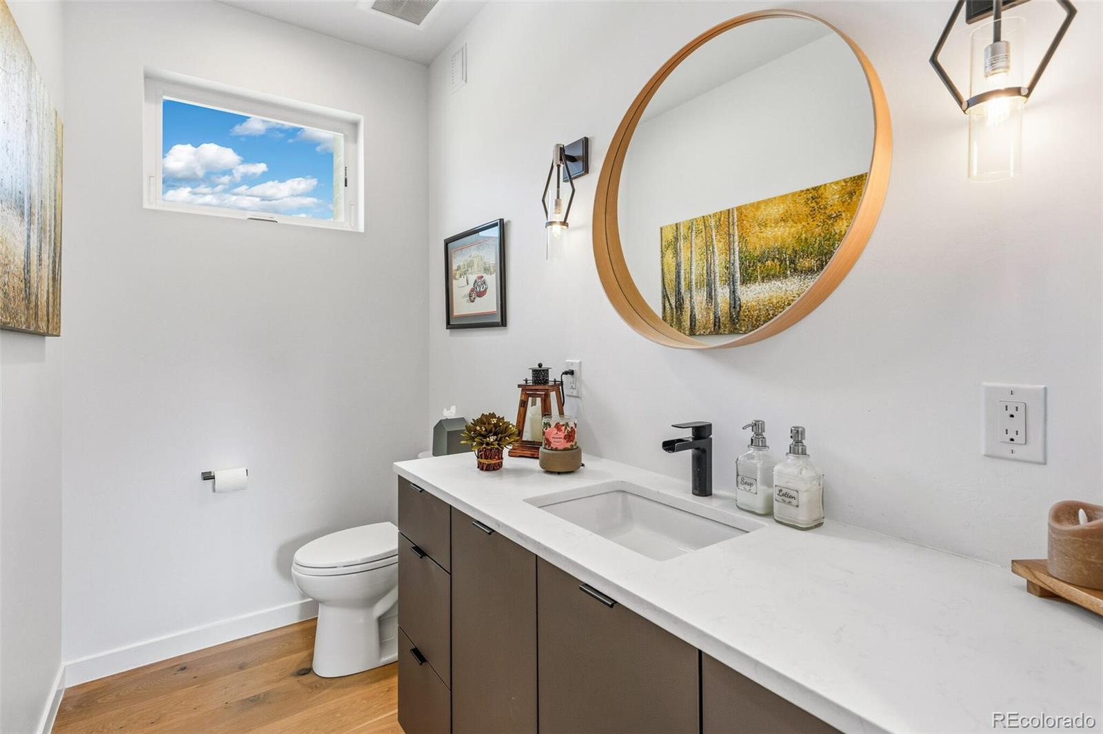 4077 Everett Street Wheat Ridge, CO 80033 - Photo 21 of 50 a bathroom with a toilet sink and mirror