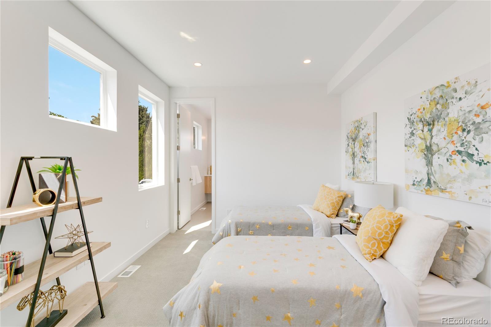 4077 Everett Street Wheat Ridge, CO 80033 - Photo 24 of 50 a bedroom with a bed and a chandelier