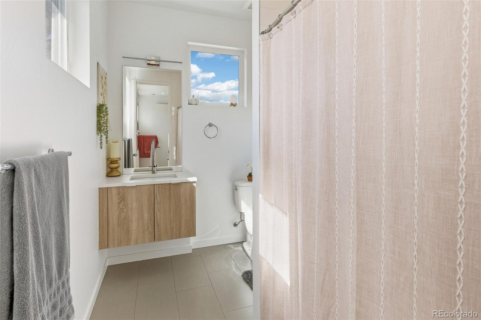 4077 Everett Street Wheat Ridge, CO 80033 - Photo 25 of 50 a bathroom with a double vanity sink and mirror