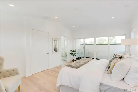 a bathroom with a white tub a vanity a sink and a window