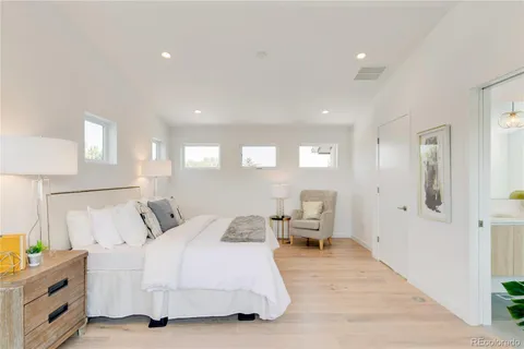 a bathroom with a granite countertop sink and a large mirror