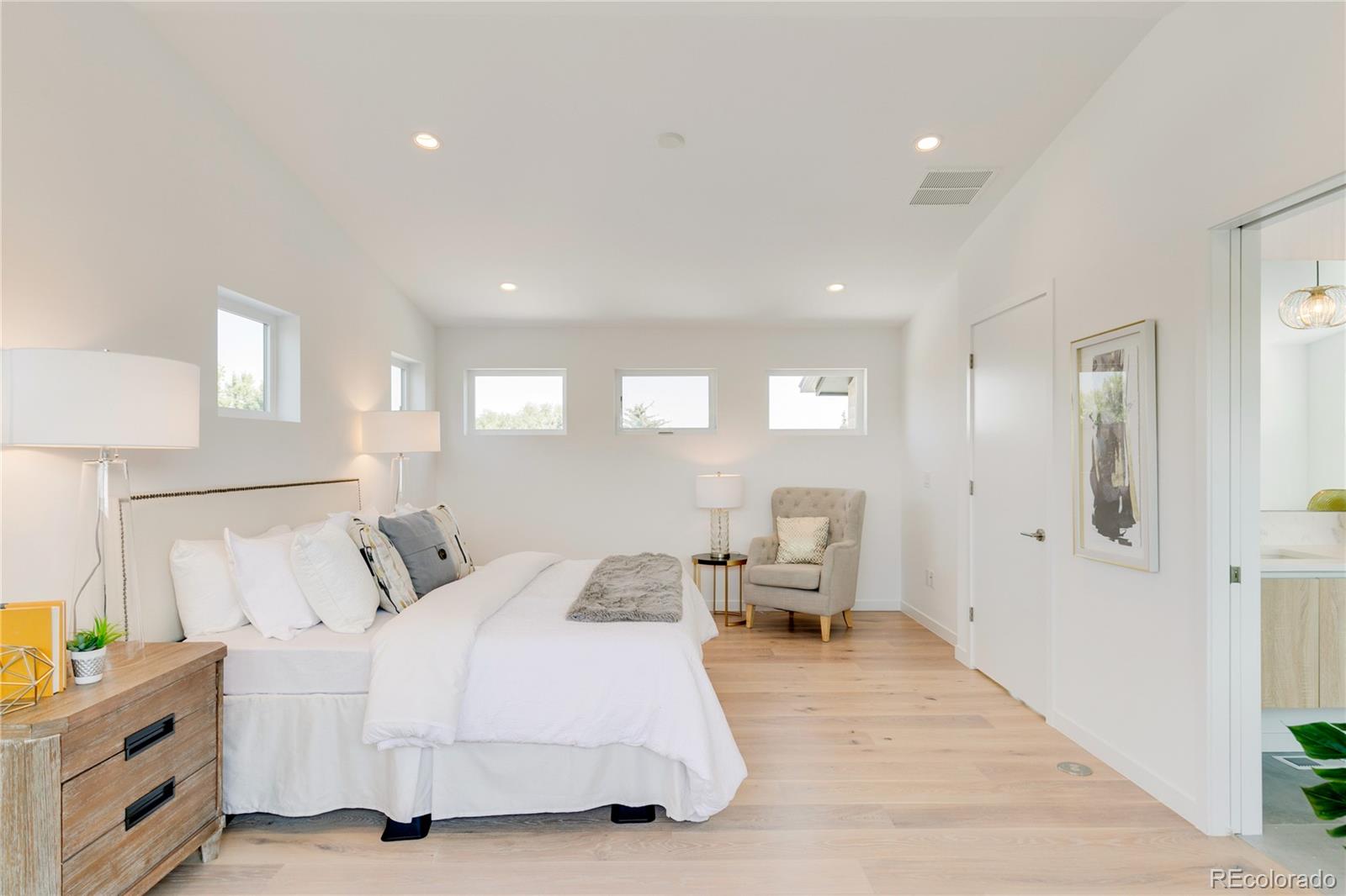 4077 Everett Street Wheat Ridge, CO 80033 - Photo 29 of 50 a bed room with a bed and a chair