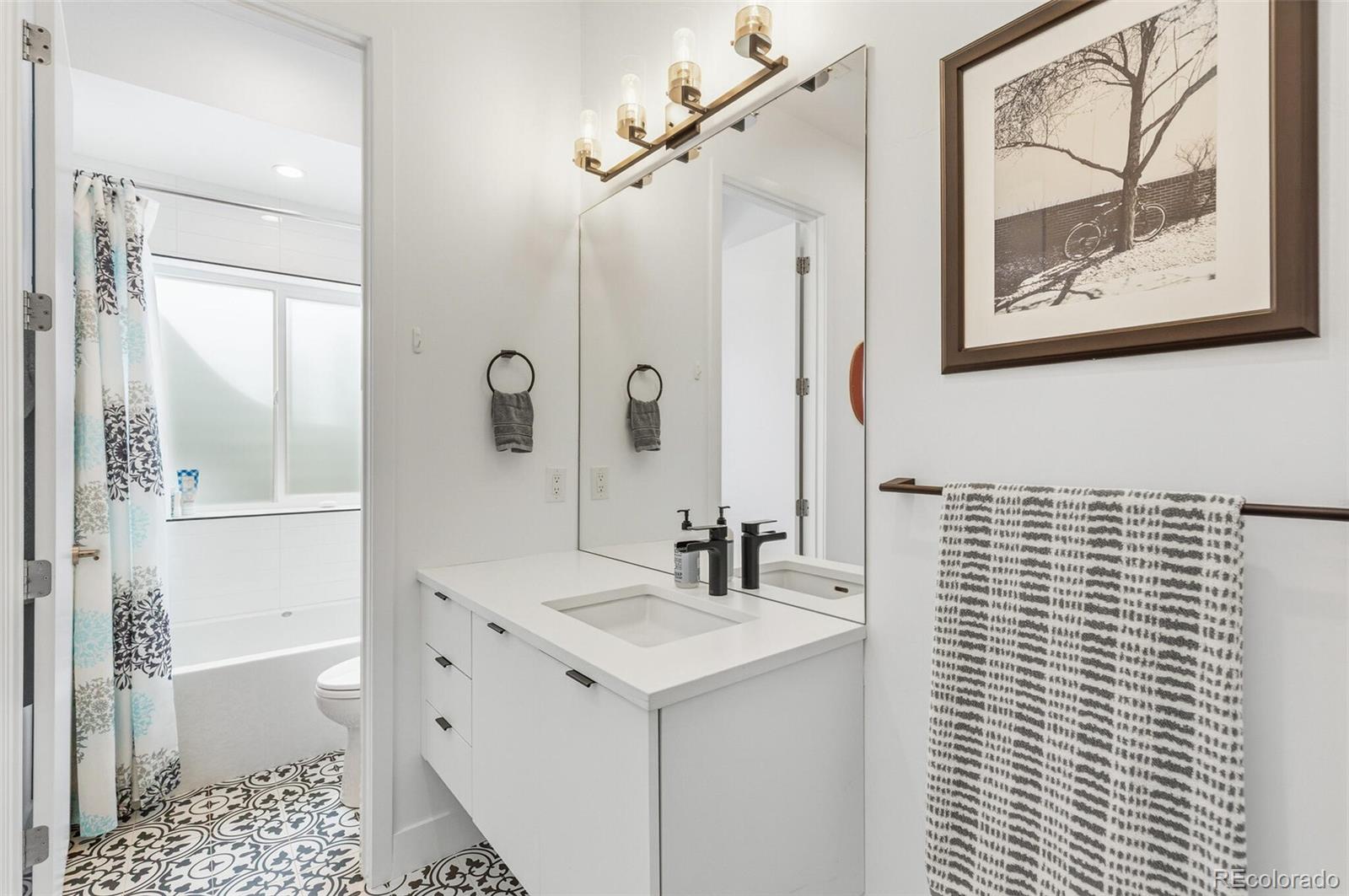 4077 Everett Street Wheat Ridge, CO 80033 - Photo 40 of 50 a bathroom with a sink a toilet and shower